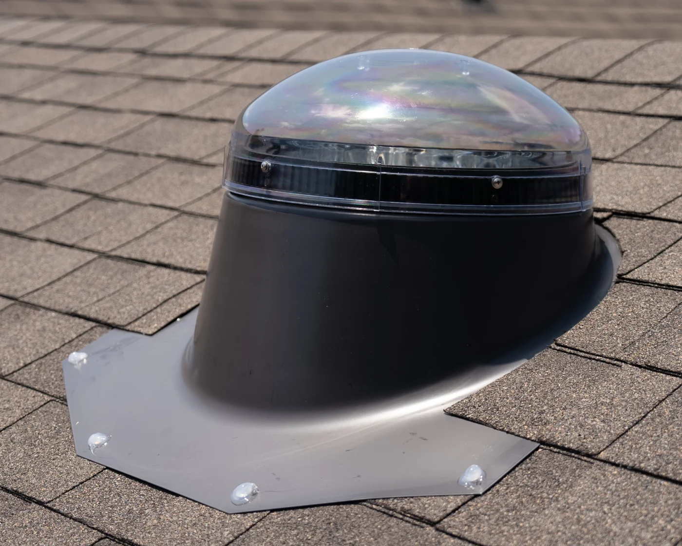 Close Up Of Velux Sun Tunnel Installation On Asphalt Shingle Roof