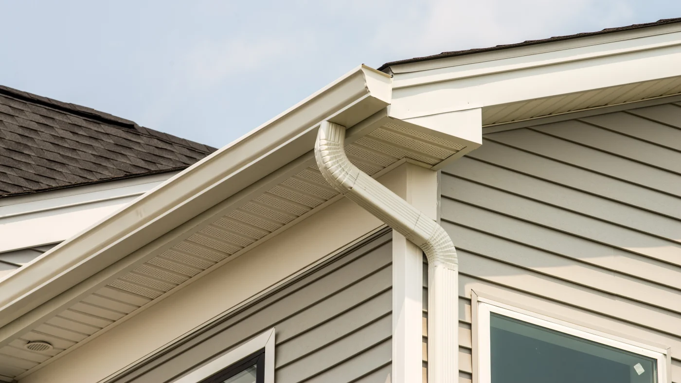 Beautiful new white gutters on a home with gray siding