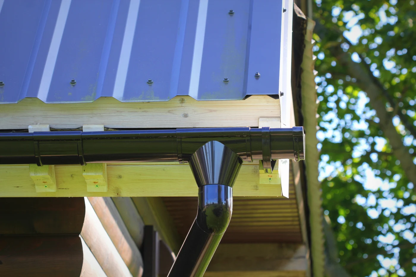 This image features a newly installed black gutter system.