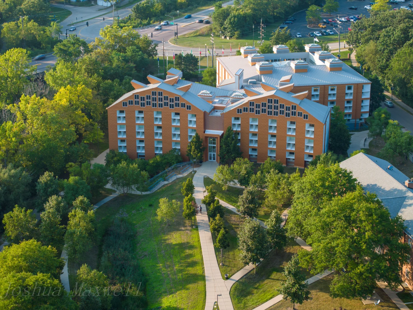 Apex Exteriors History In The South Elgin, Chicagoland Area An aerial drone view of Judson University in South Elgin, Illinois, surrounded by trees, walking pathways, and parking lots and streets in the distance.