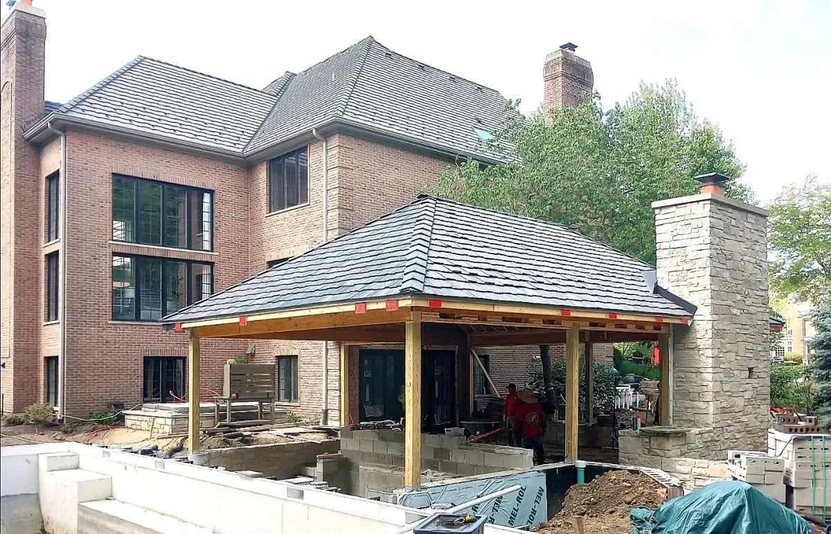 A large residential brick structure with three floors and a large newly-constructed gazebo with new DaVinci shake roofing done by Apex Exteriors in St. Charles, Illinois.