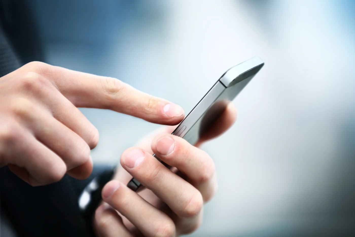 Apex Exteriors Chicagoland Exterior Projects Process – Step 1 – First Contact Close-up of a person’s hand tapping on a smartphone screen, symbolizing the first contact with Apex Exteriors. The blurred background adds a professional tone, reinforcing the idea of initiating service via phone or online form.