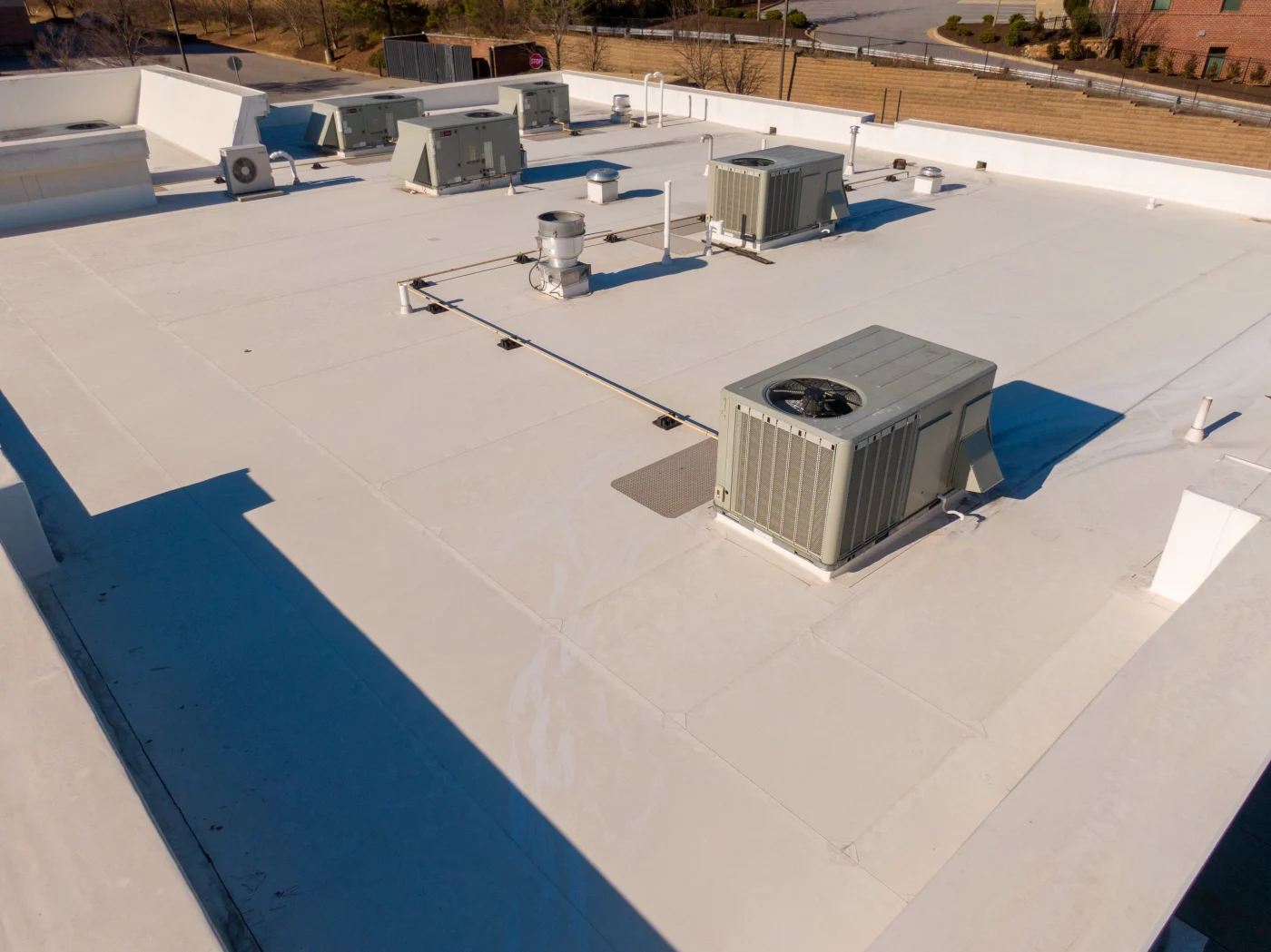 Close-up of a clean, professionally installed flat commercial roof with multiple rooftop HVAC units—demonstrating high-quality workmanship, proper equipment integration, and a smooth finish that reflects Apex Exteriors' commitment to speed without sacrificing standards.