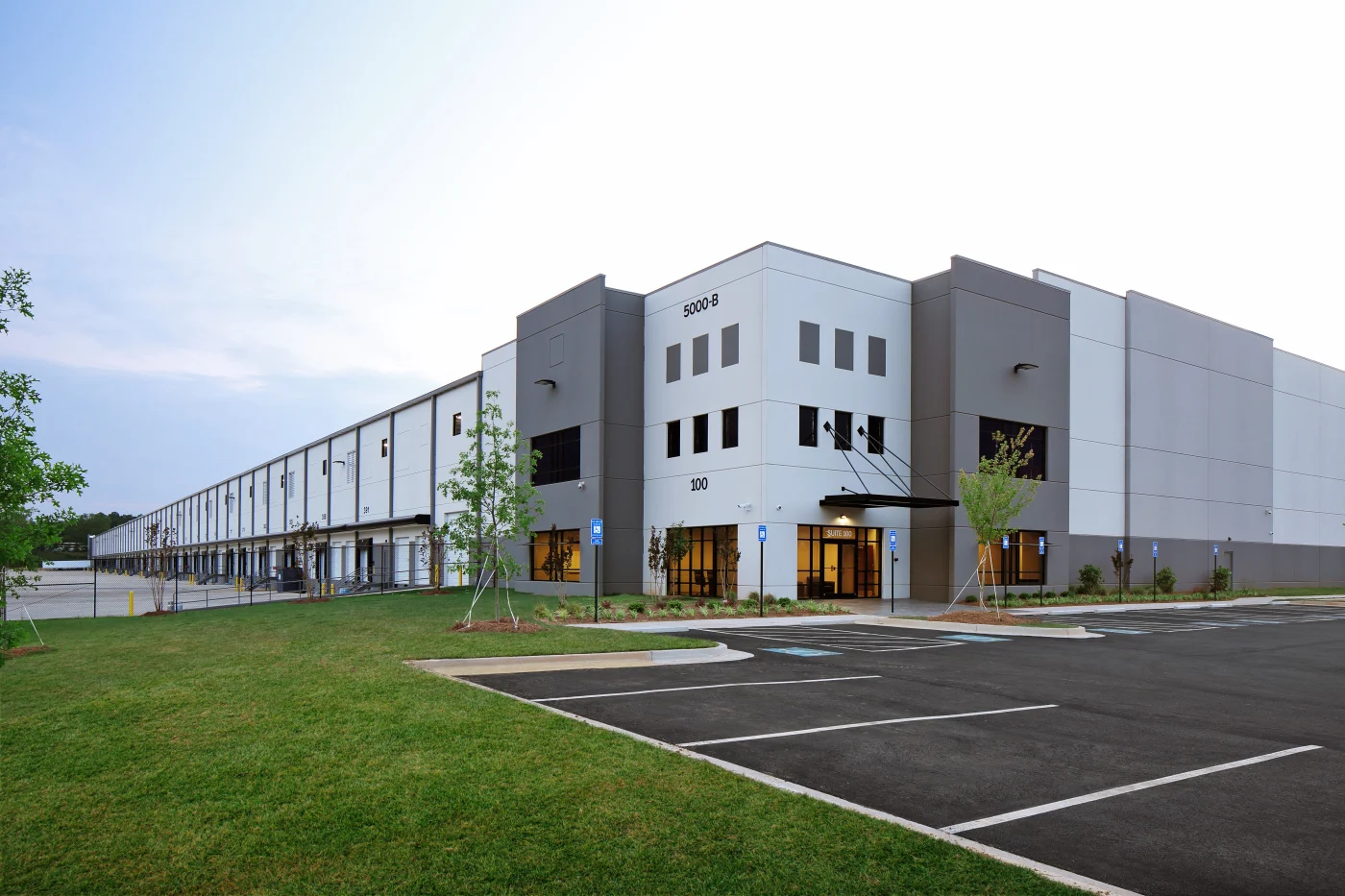 Modern Gray Industrial Warehouse Distribution Building And Parking Lot