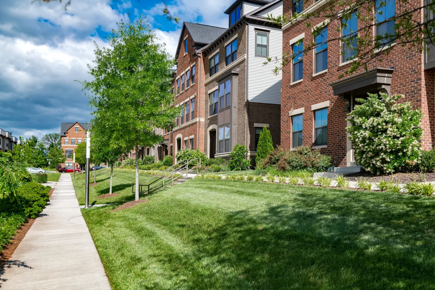 Row Of Modern Multi Family Townhouses With Landscaping.