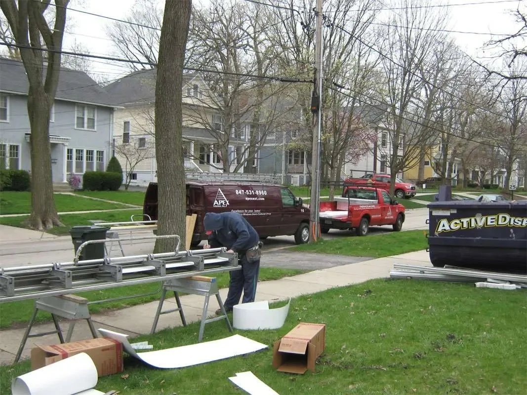 Apex Exteriors Specialist Working Outside Chicagoland Home During Roof Repair Servicing Project