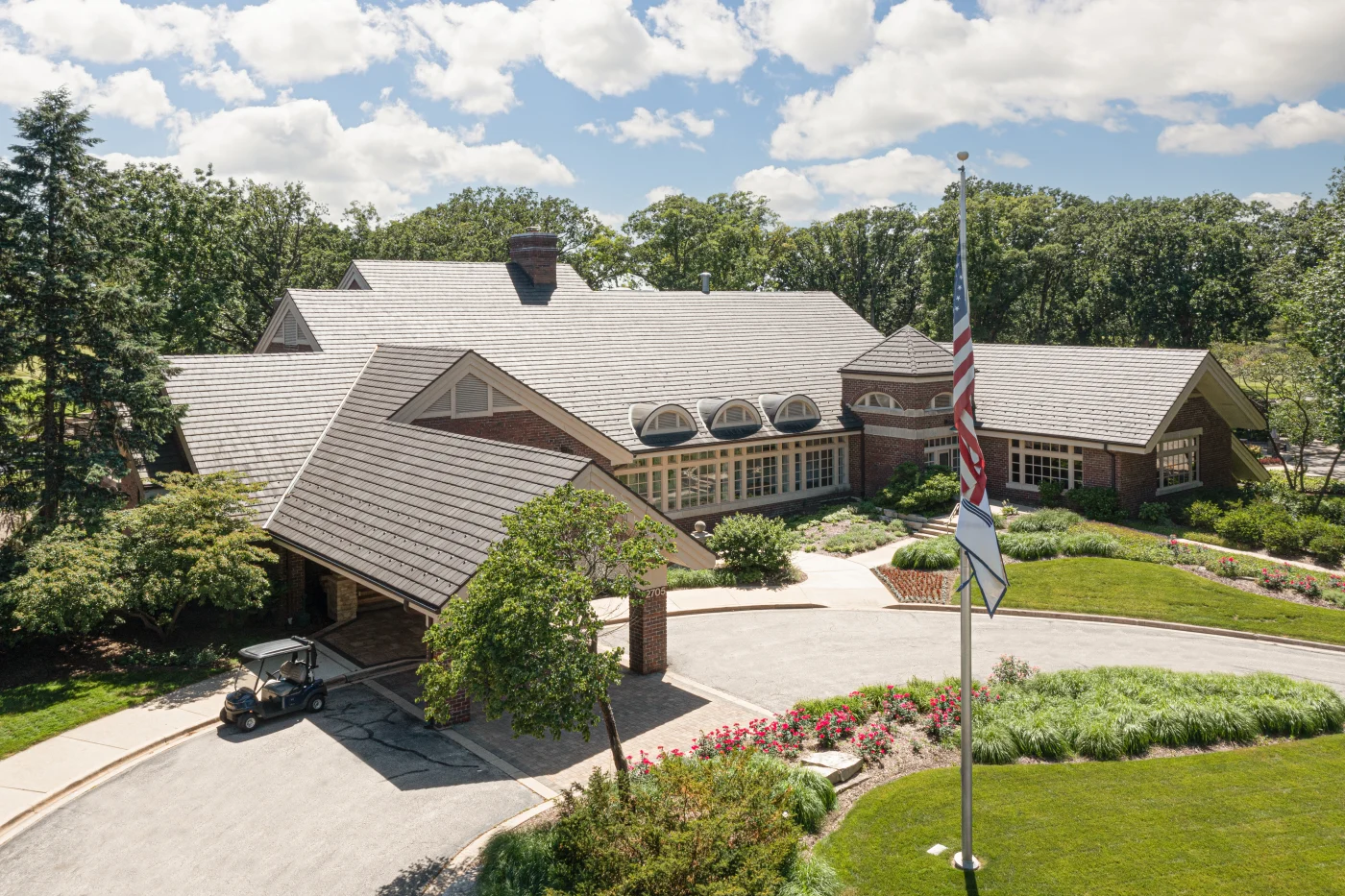 A bird's eye view shot of a country club's brand new asphalt roof.