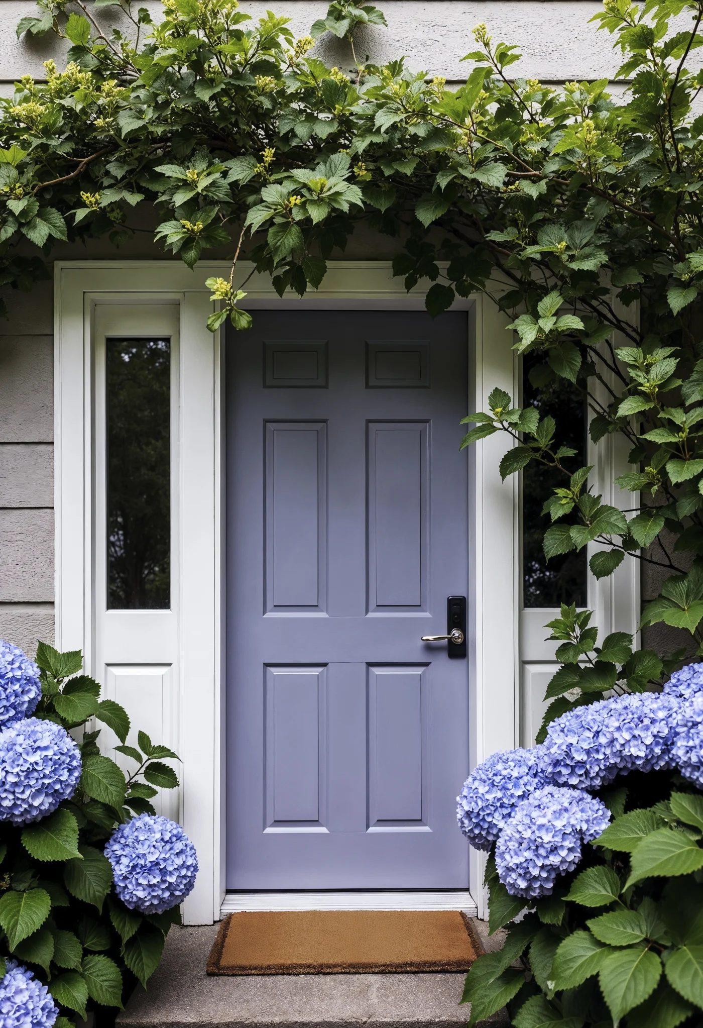 Lavender door on front of house with ivy and hydrangea flowers