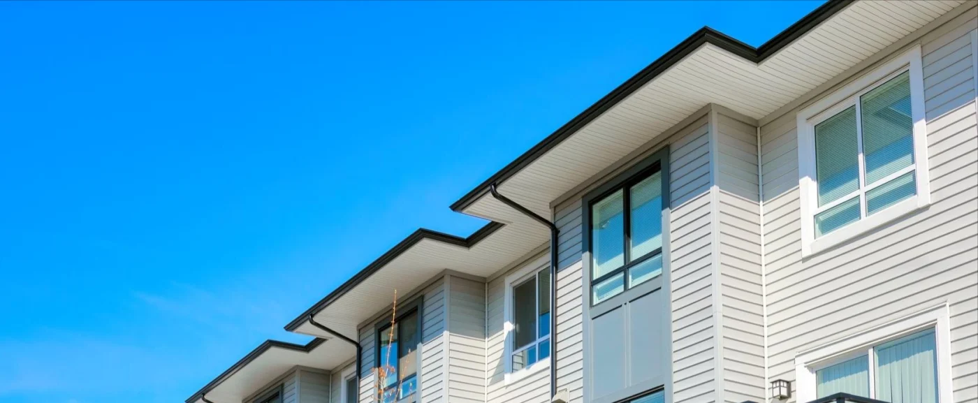 Close-up image of siding, fascia, and soffits on apartment buildings