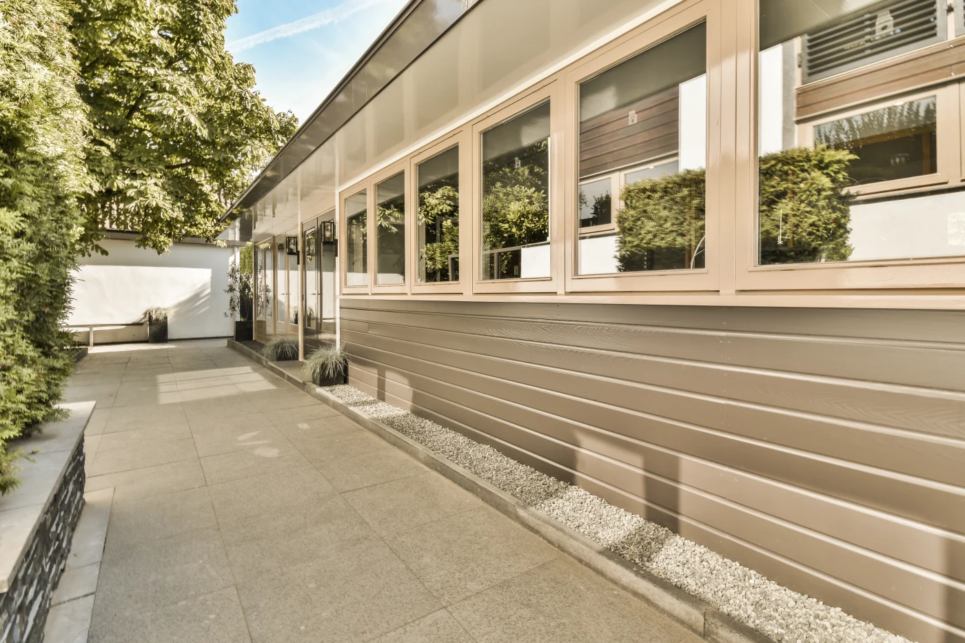 Image of a commercial building with large windows and cedar siding