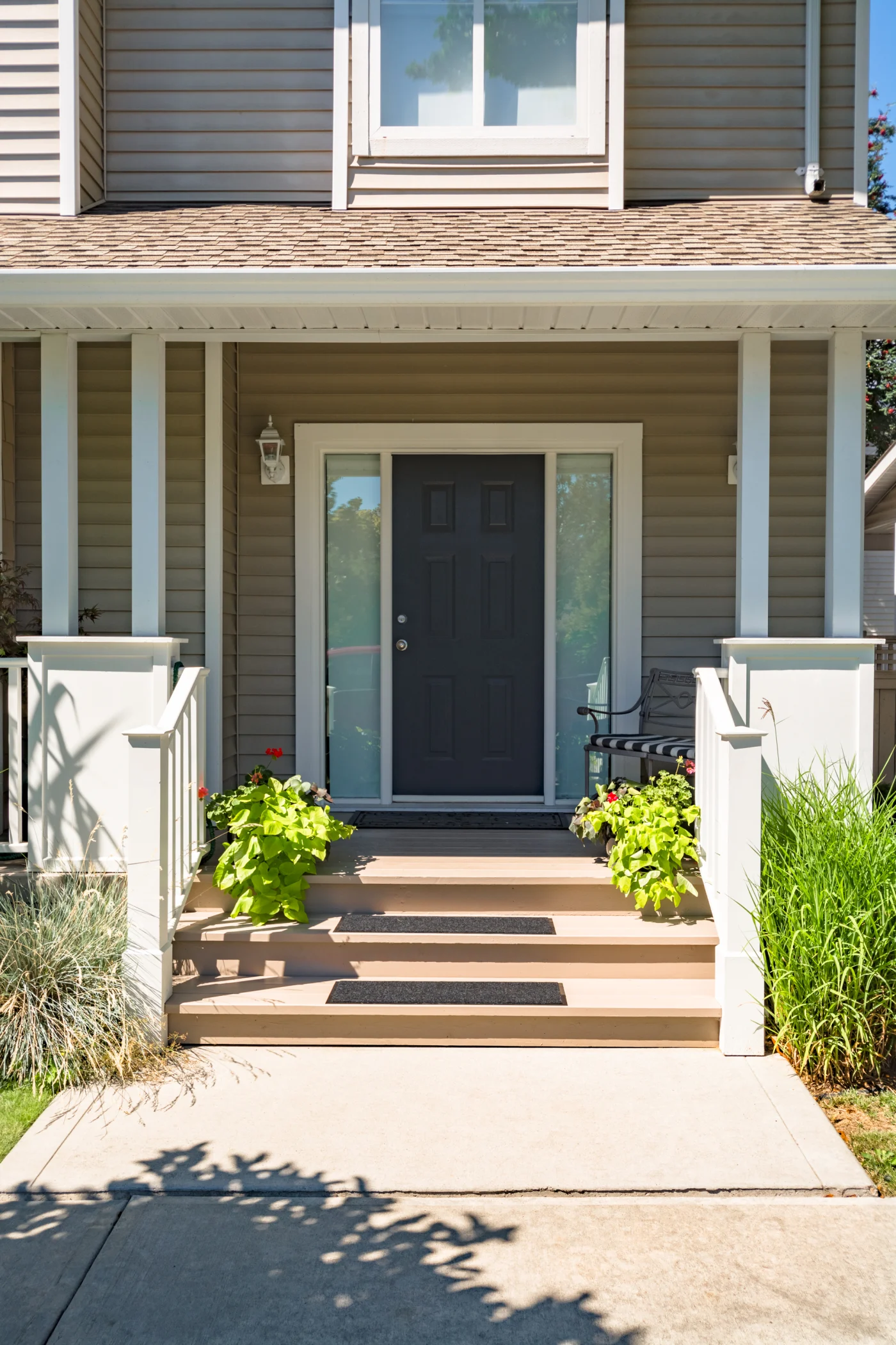 Beautiful entry door on front of house with two sidelight windows