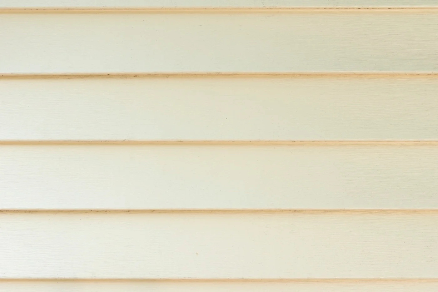Close-up view of high-quality vinyl siding in an inviting beige shade.