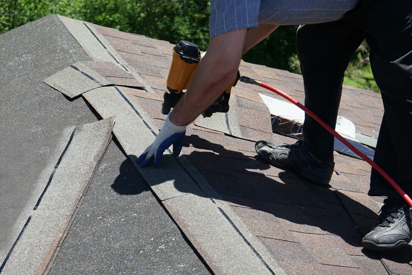 Roofer replacing asphalt shingles