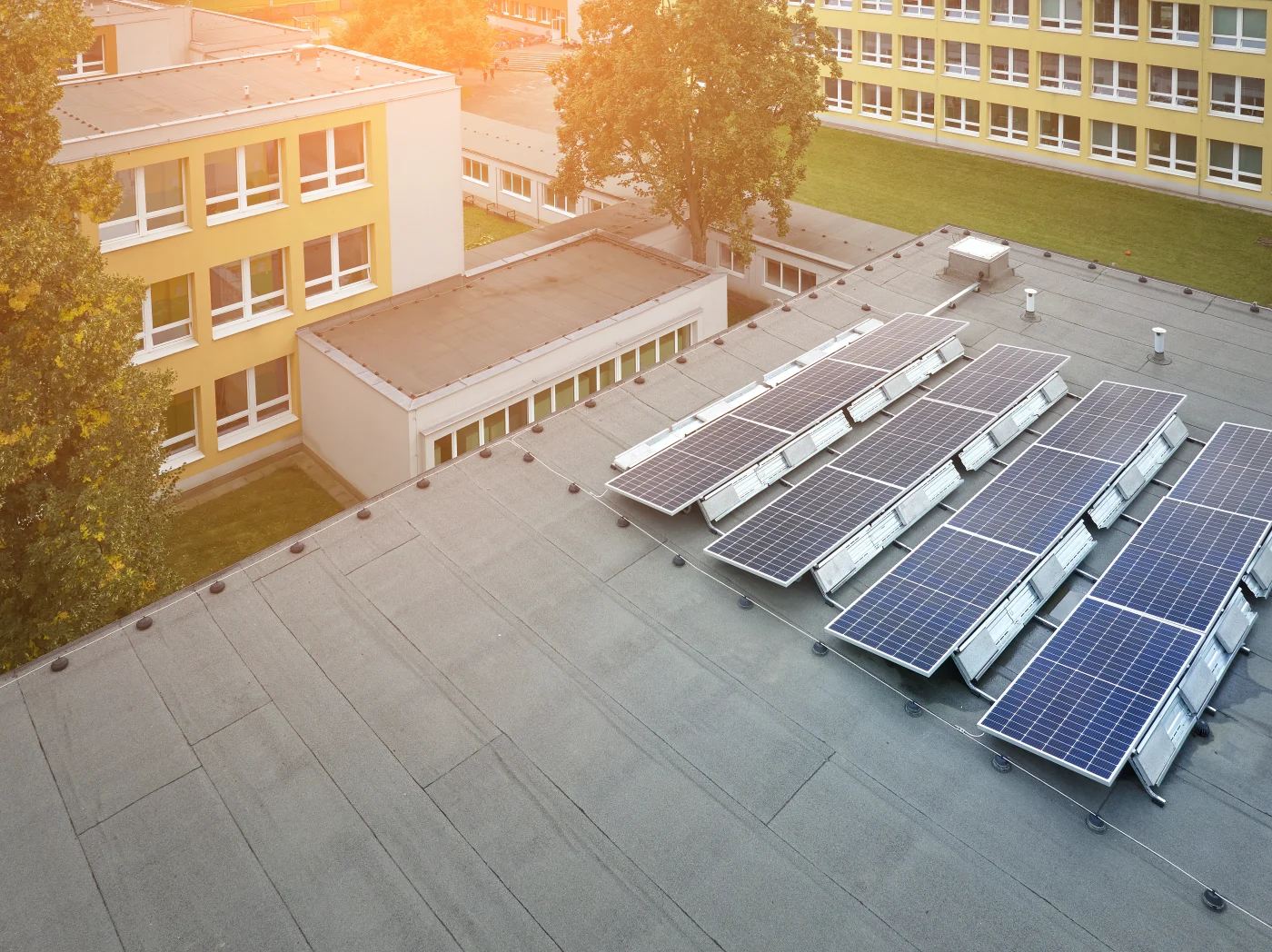 Aerial view of a commercial building with solar panels on it