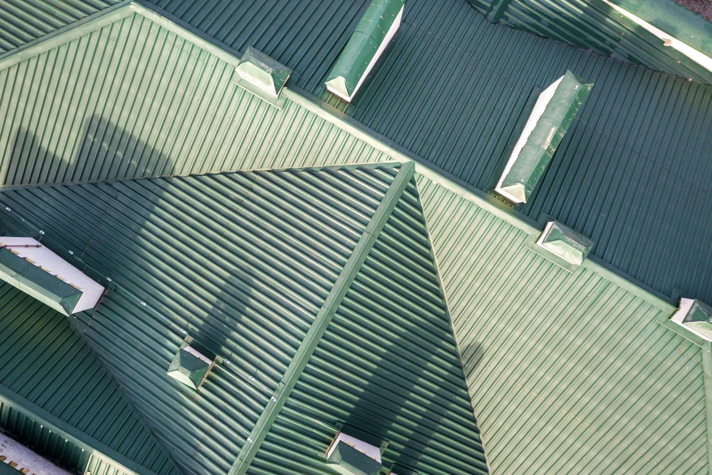 The image shows a close-up of a green metal roof. It looks like it was newly installed.