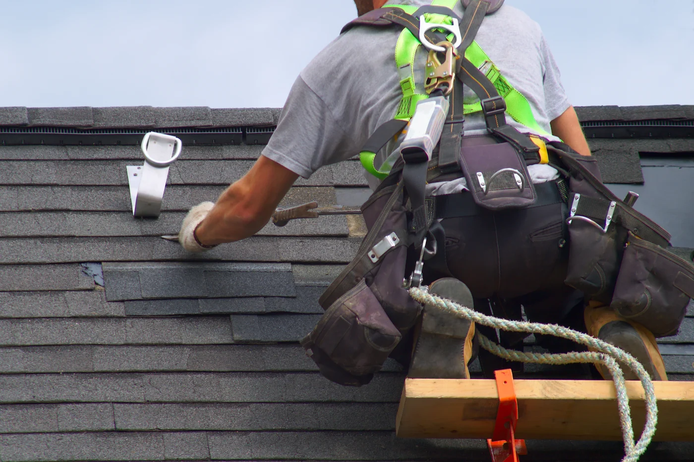 A skilled worker carefully constructs a roof on a new home.