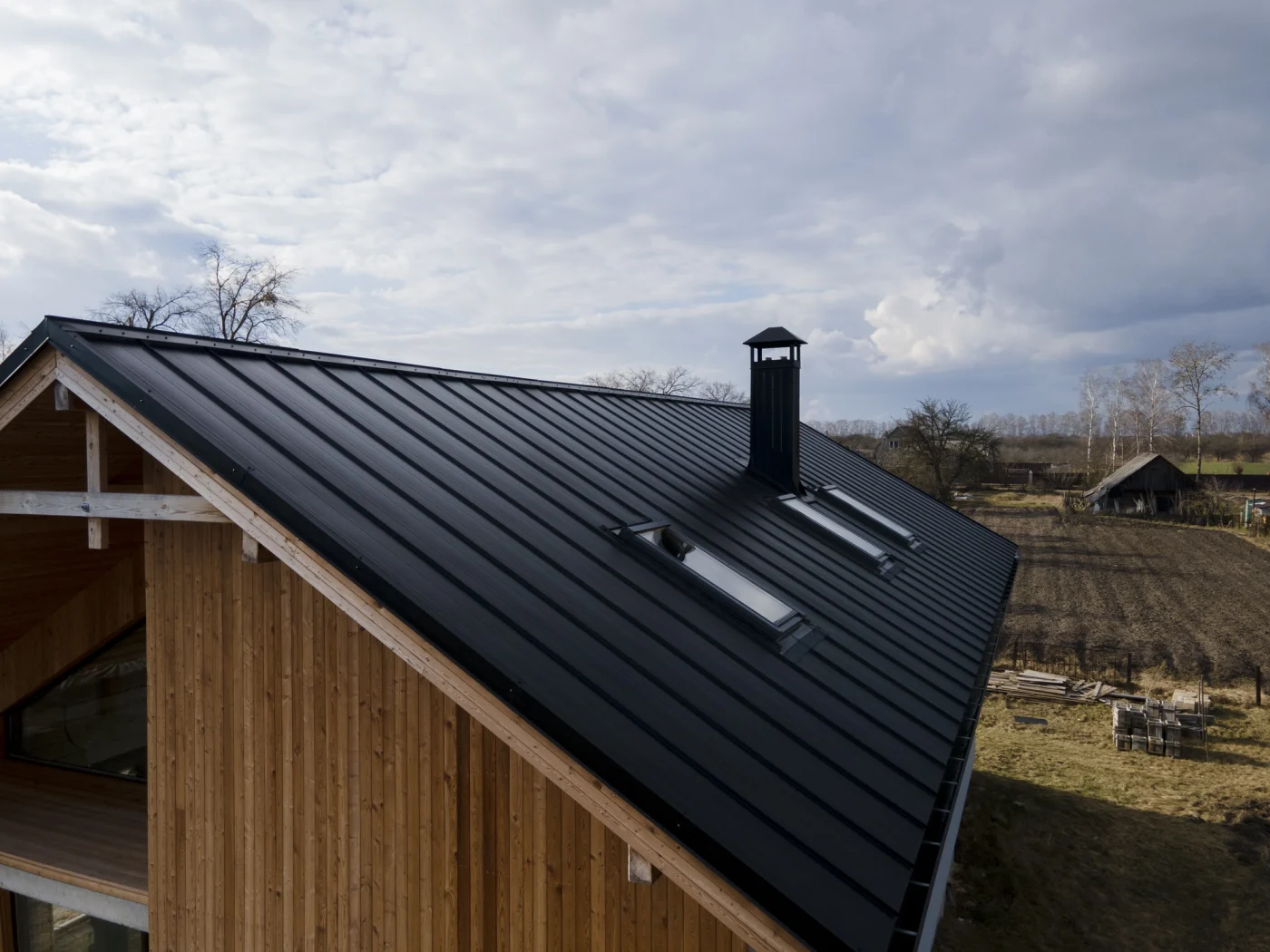 Black metal roof on home with skylights
