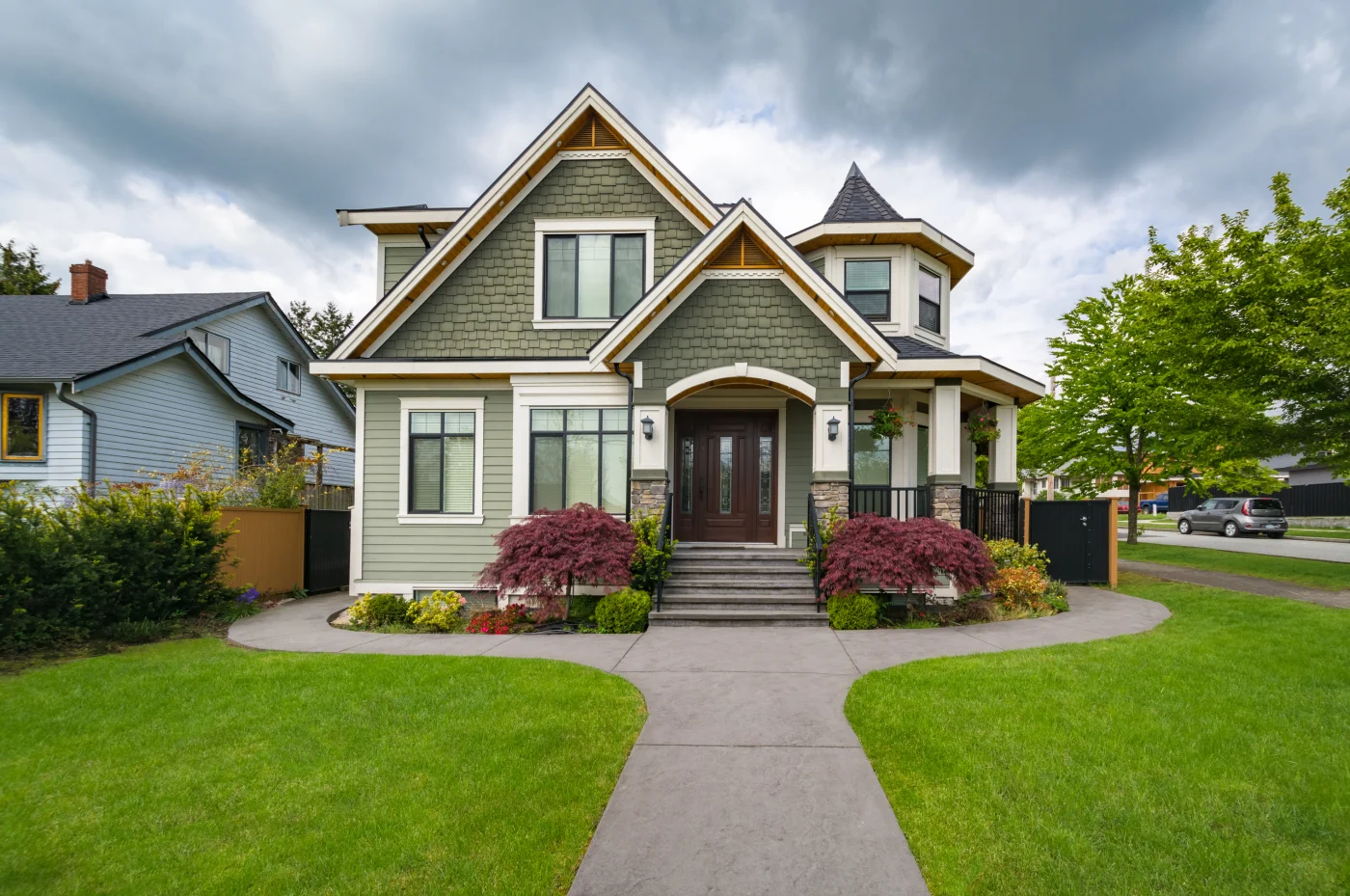 Home with green siding, new windows, and a wooden entry door for a classic look