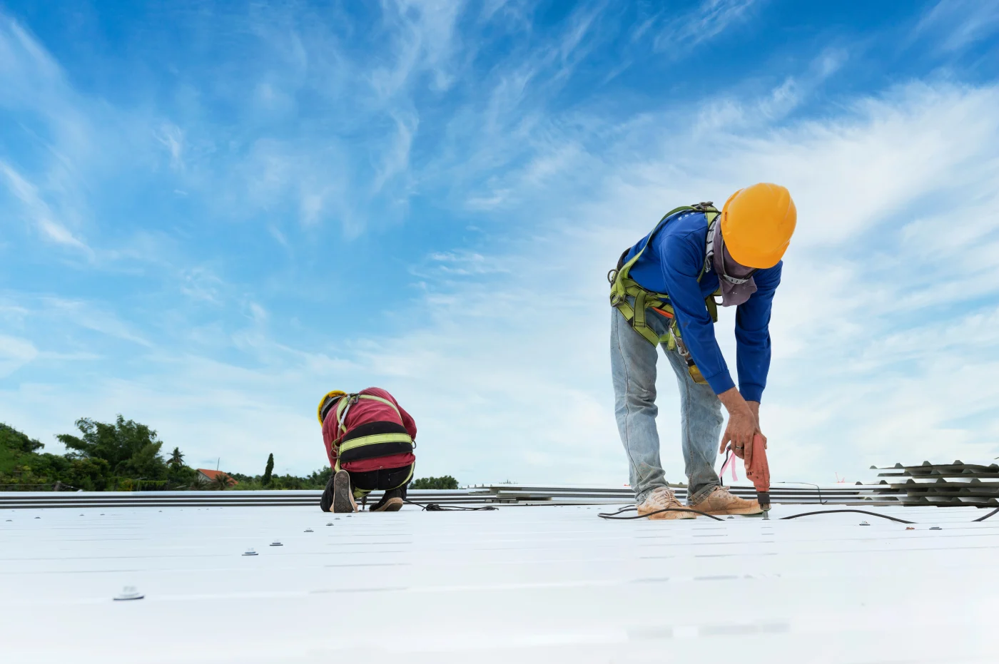 Roofers repairing a flat commercial roof