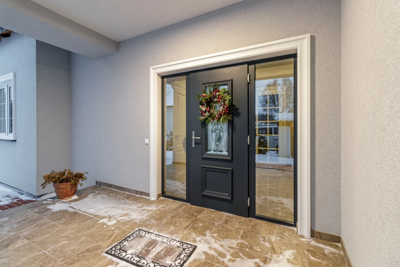 Navy blue entry door with sidelights on each side of door