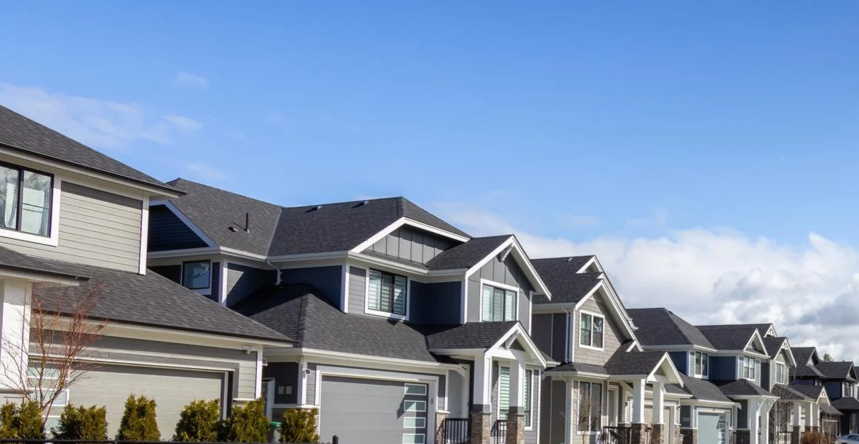 Image of similar-looking homes within an HOA neighborhood against a blue sky