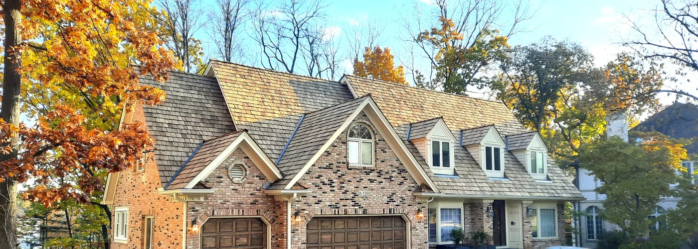Image of a home with cedar shake shingles and stone siding