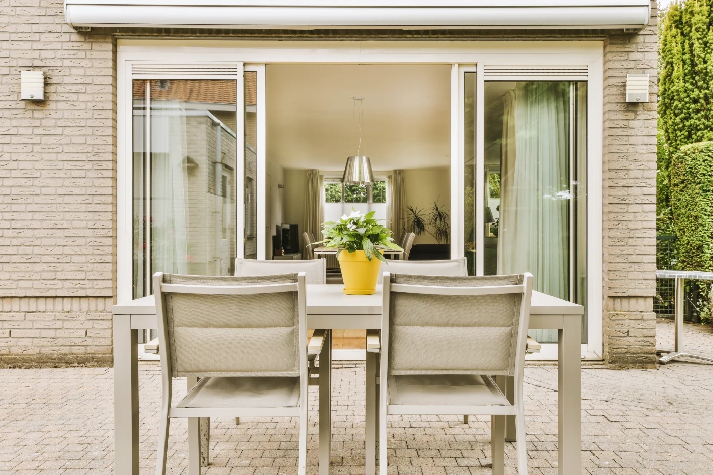 Image of a patio with a table with open sliding patio doors behind it