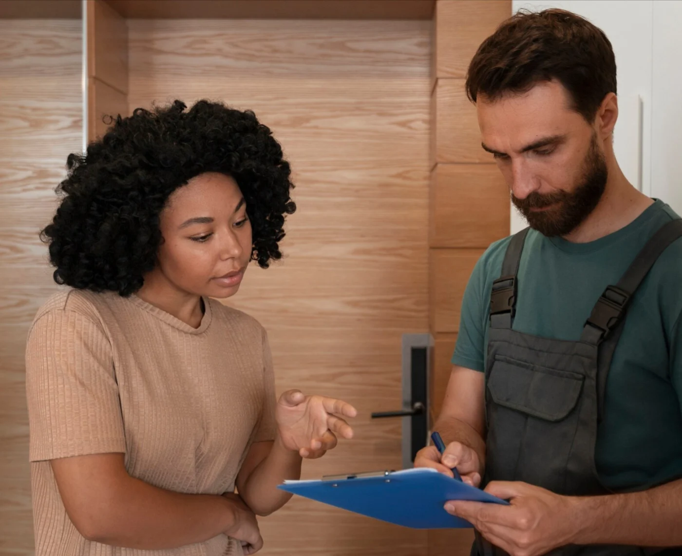 Image of a roof inspector speaking to a woman about roof damage
