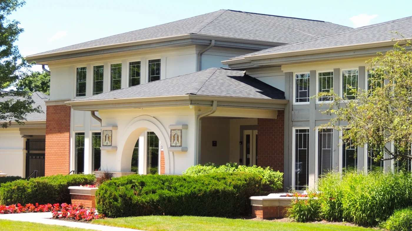 Community Clubhouse with brick siding and asphalt shingle roof