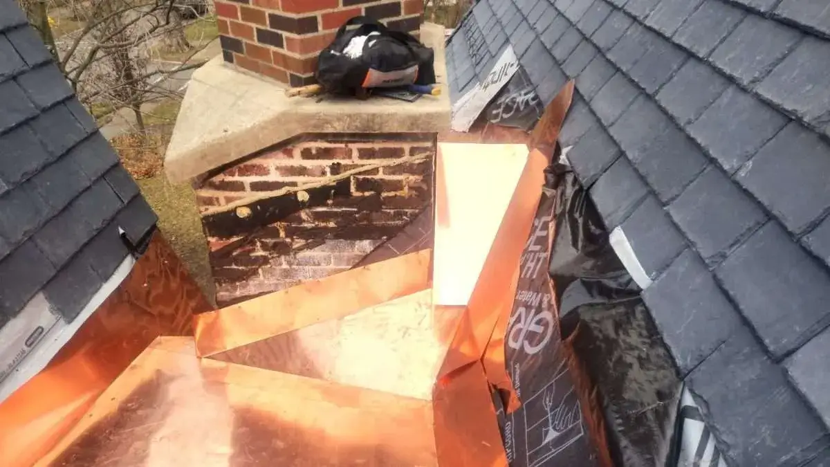 Close view of the installation of John’s customized copper roof pan