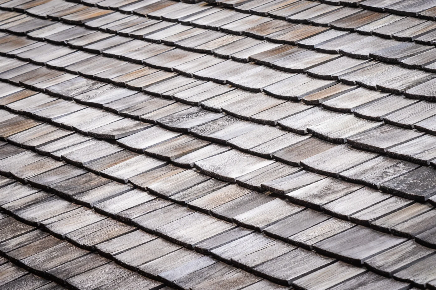 Quality asphalt roofing shingles in prime condition on a residential home.