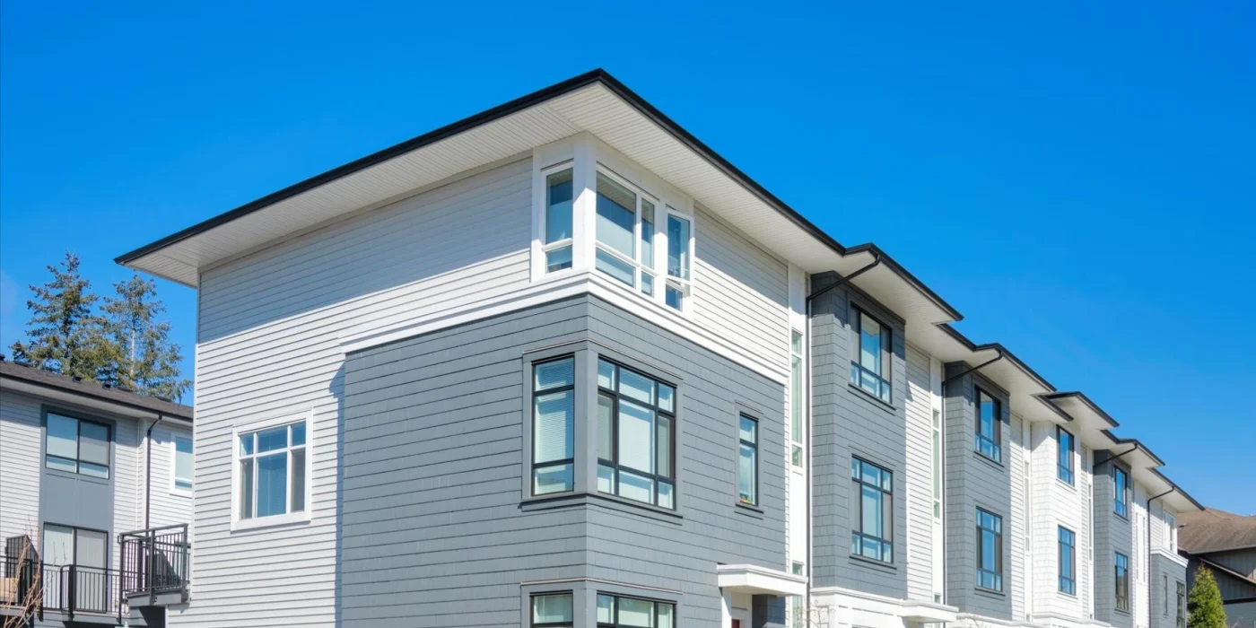 Image of townhouses with new white and grey siding
