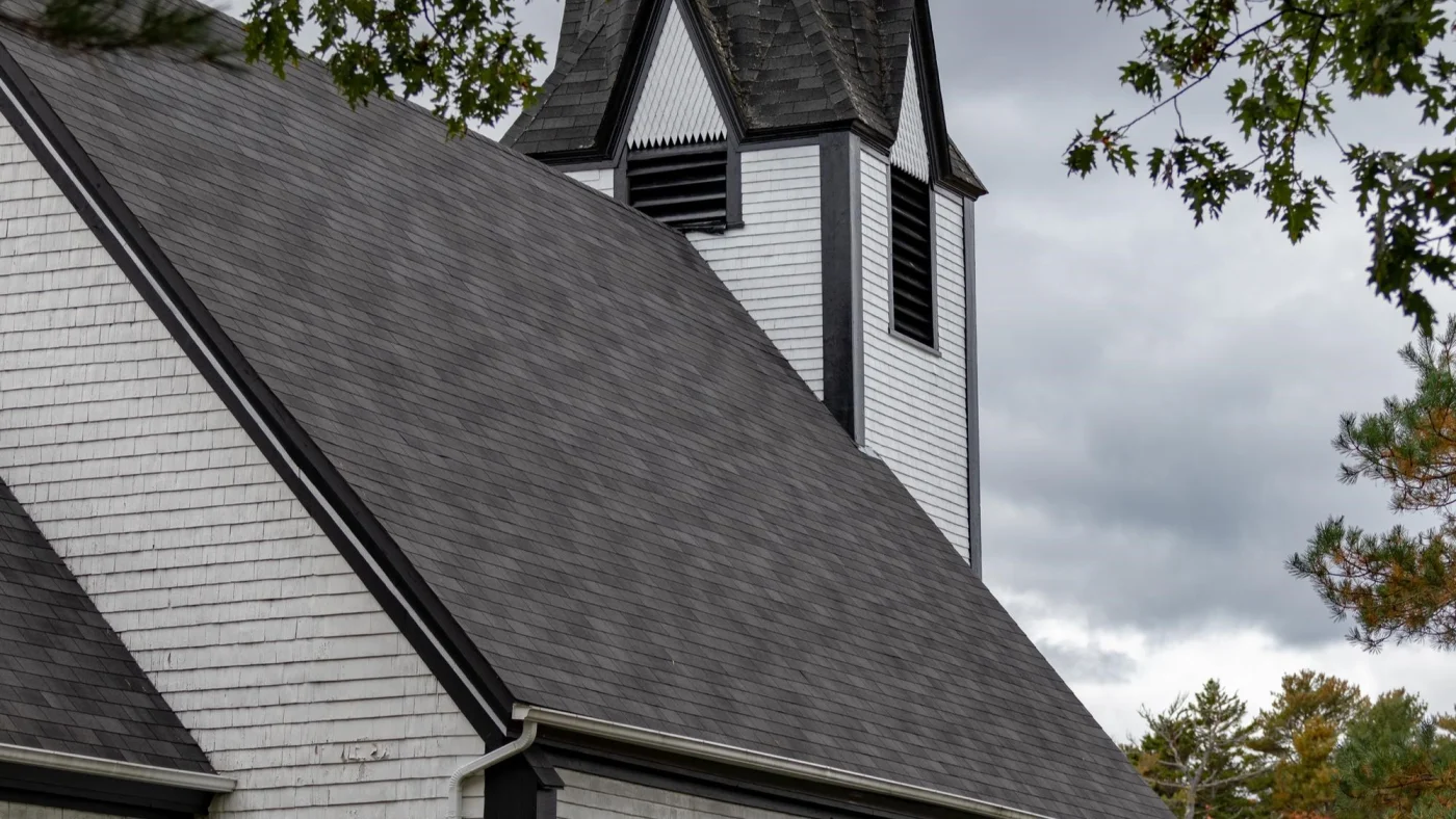 Close-up side view of grey asphalt shingle roof