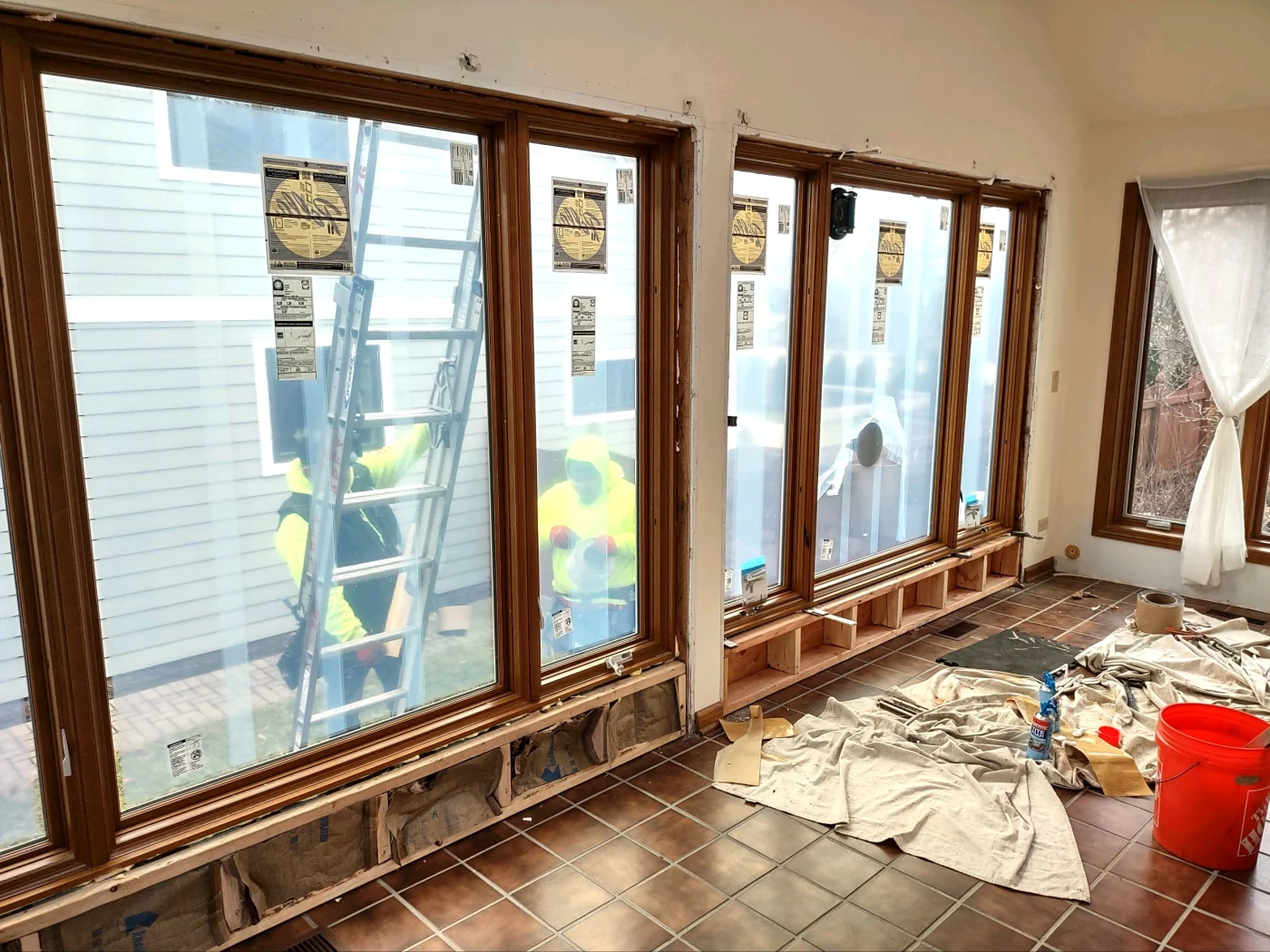A person carefully puts in the finishing touches of a newly installed window.