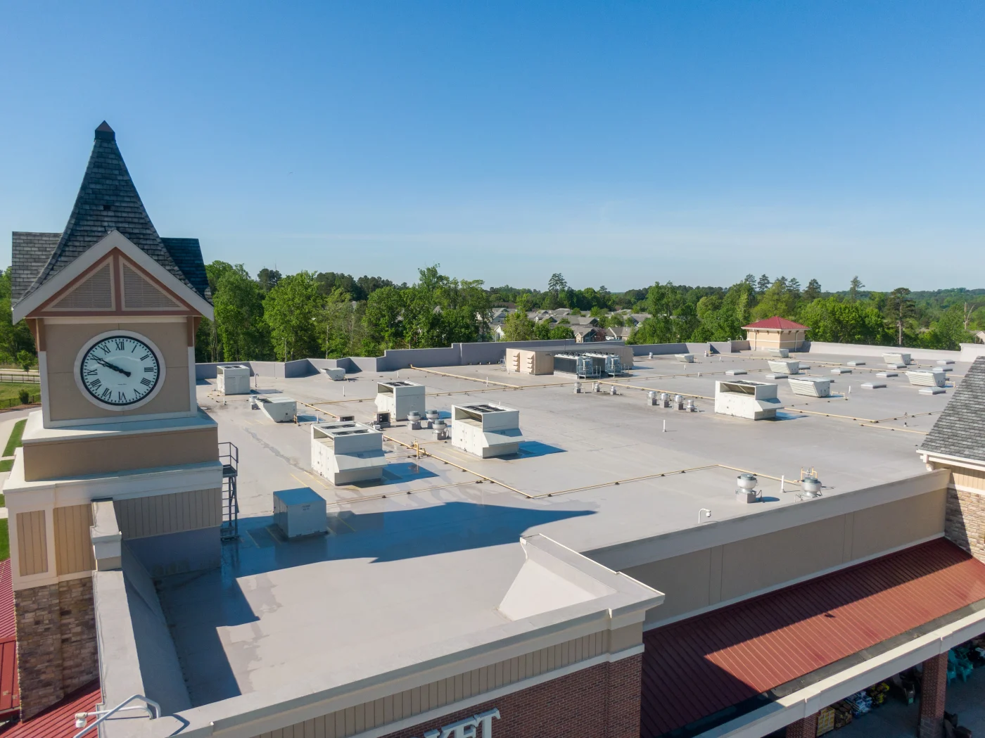 Flat commercial roof on building set against blue sky in Northbrook, IL
