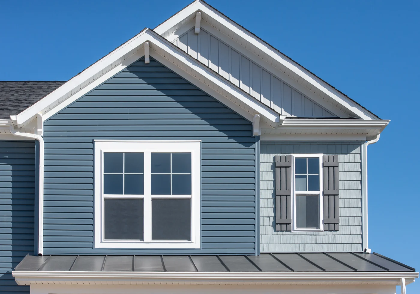 Top of a house with blue siding