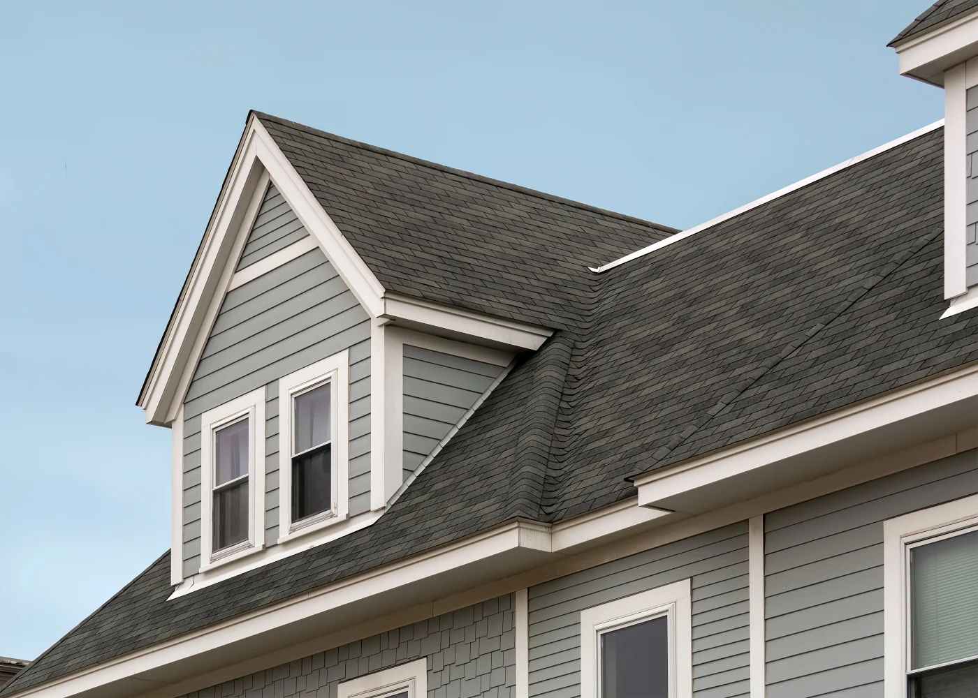 Close up of an asphalt shingle roof on a two-story house