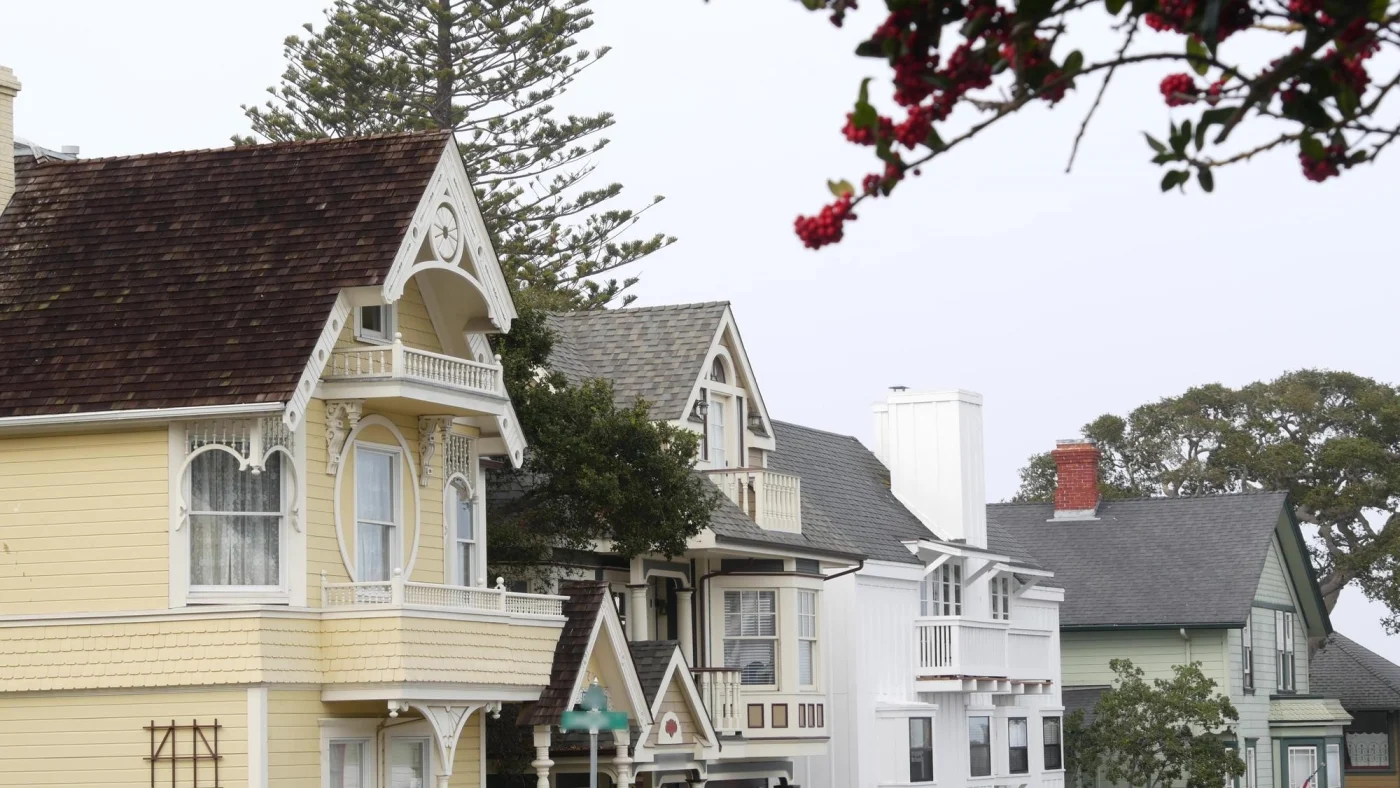 Side view of houses with various asphalt shingle roofs