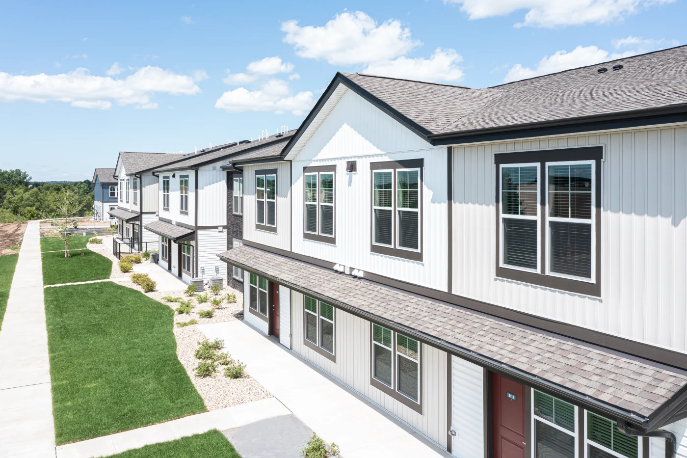 A slightly angled shot of the front of an apartment building with new gutters.