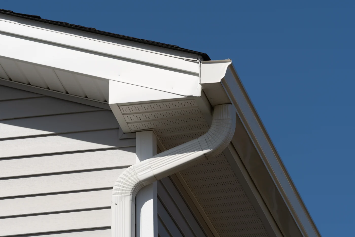 Close-up image of white gutters on a house