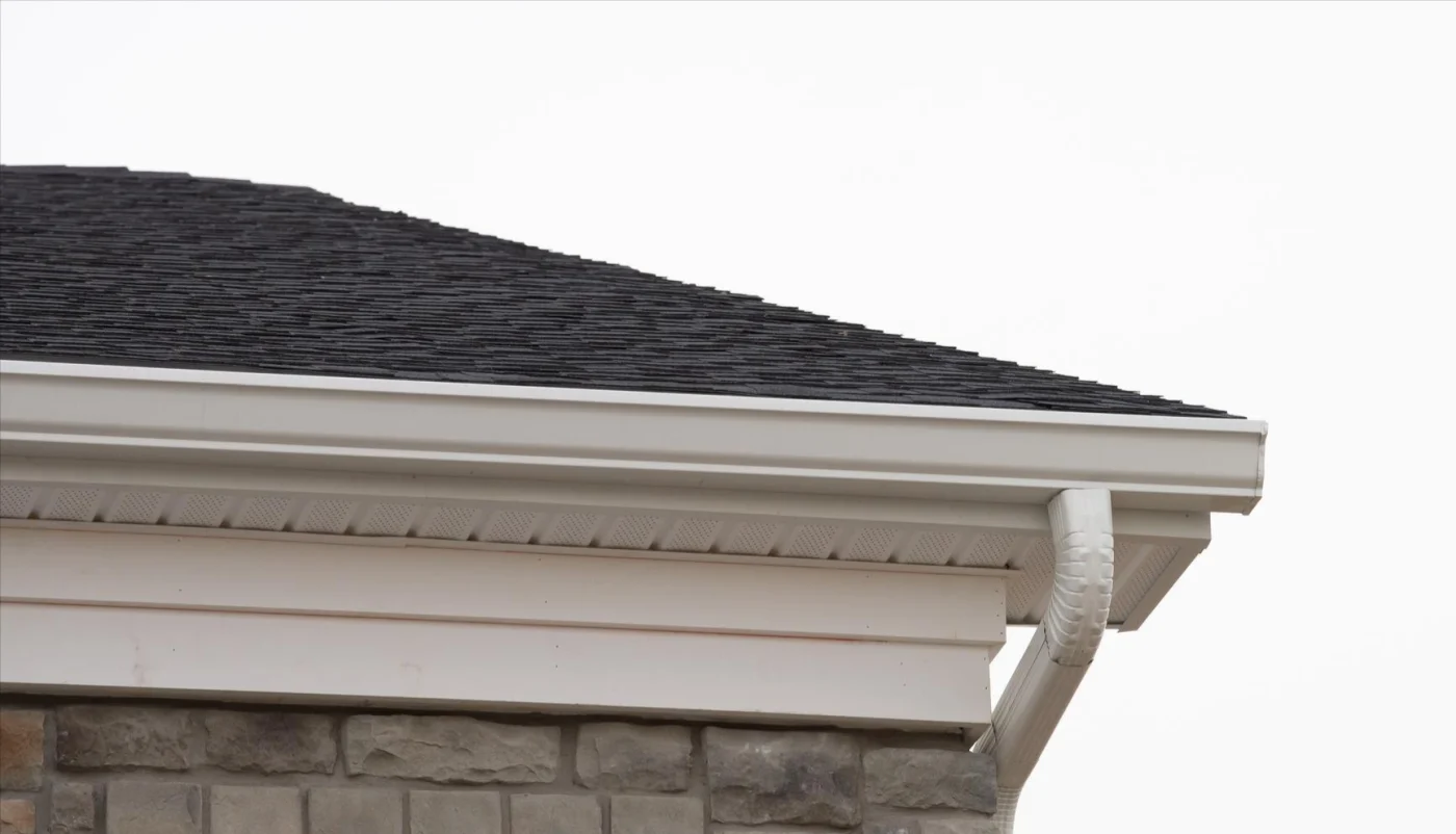 Close-up of a home with white gutters, soffits, and fascia
