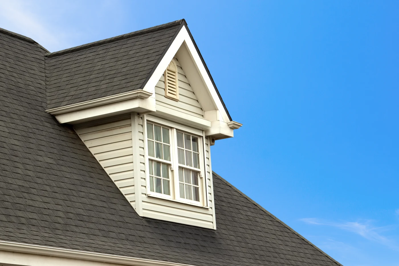 Charming House With Dormer In Clear Blue Sky