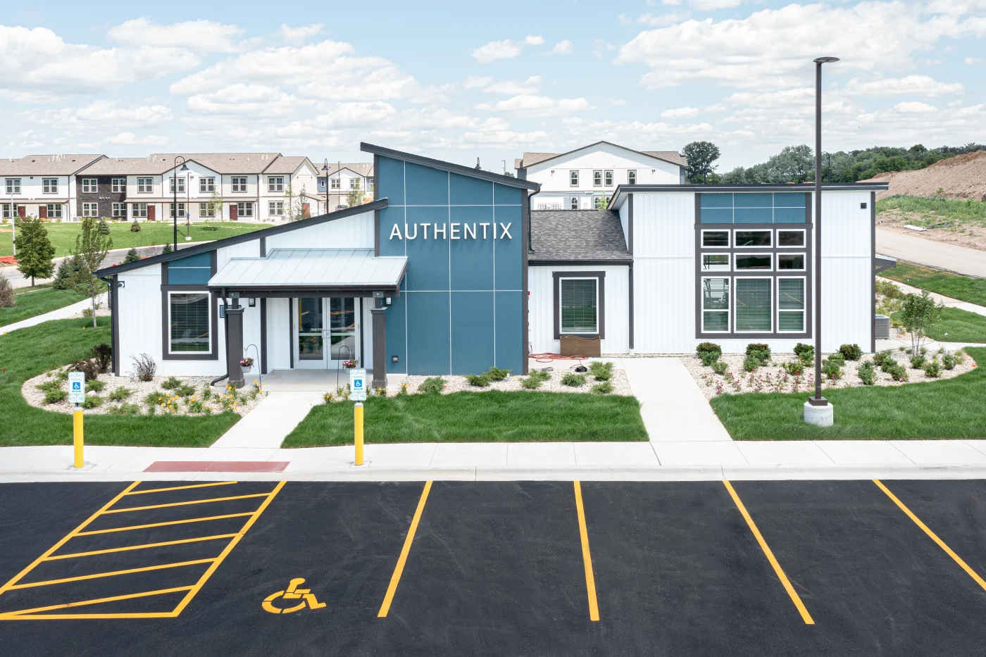 Image of an apartment complex clubhouse with white siding
