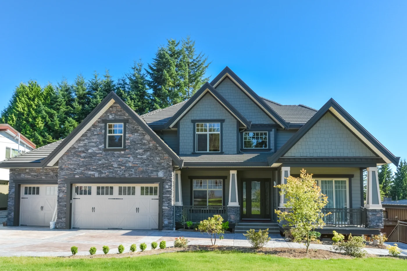 A far-off image of a house with a stone veneer