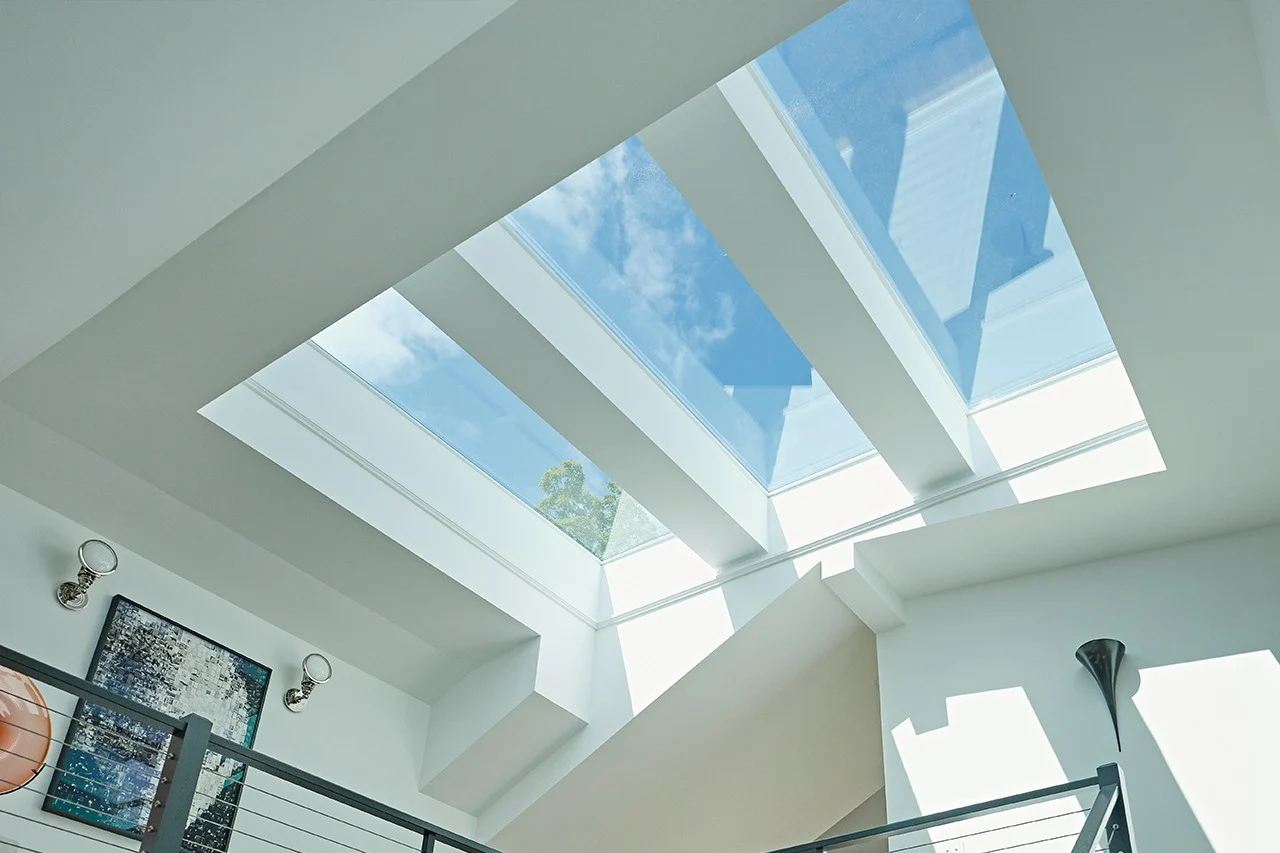 Image of three rectangle-shaped skylights during a sunny day with blue sky