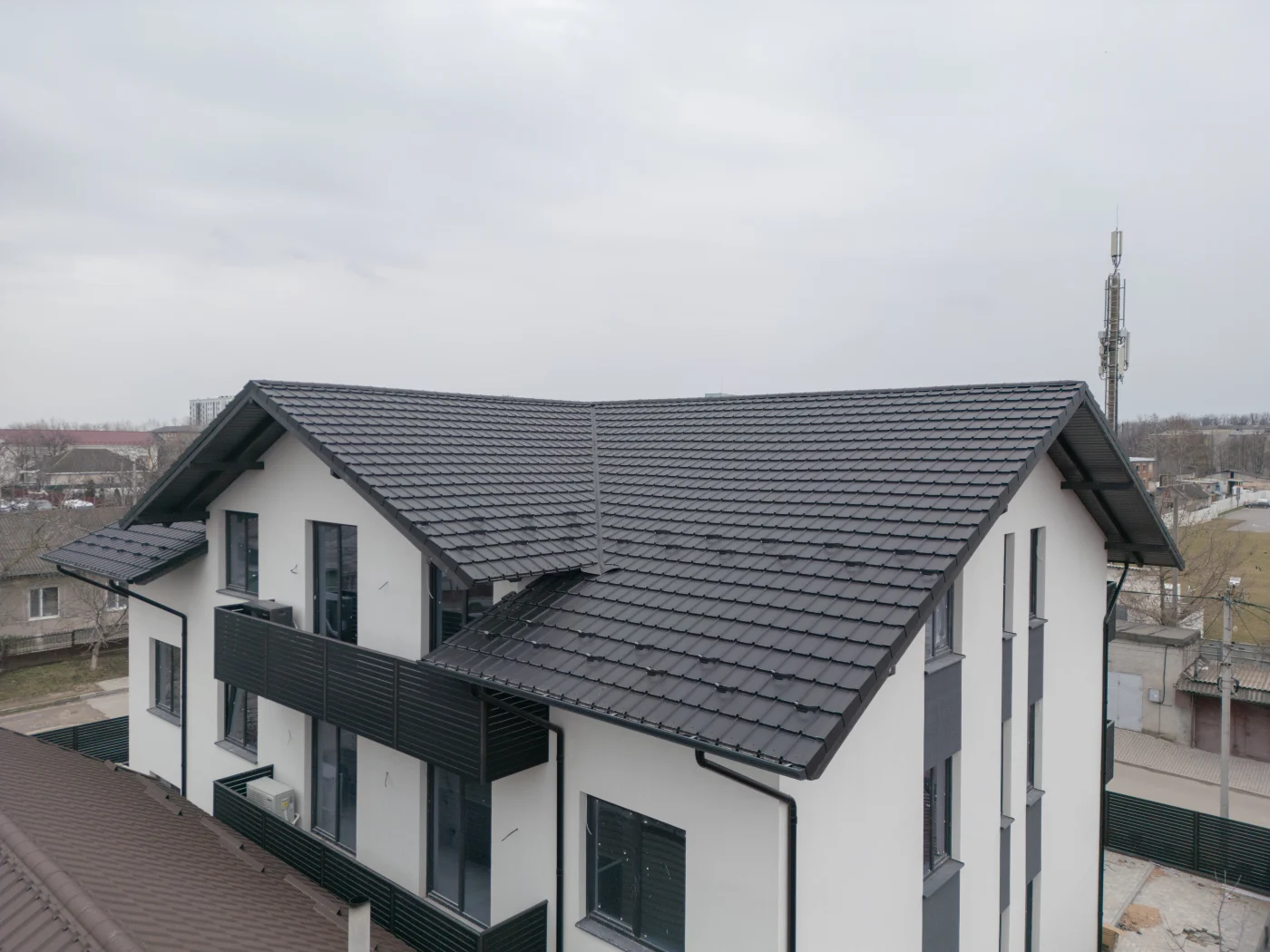 Modern Two Story Building With A Sleek Black Roof And Contemporary Design. Modern Two Story Building With A Sleek Black Roof And Contemporary Design.