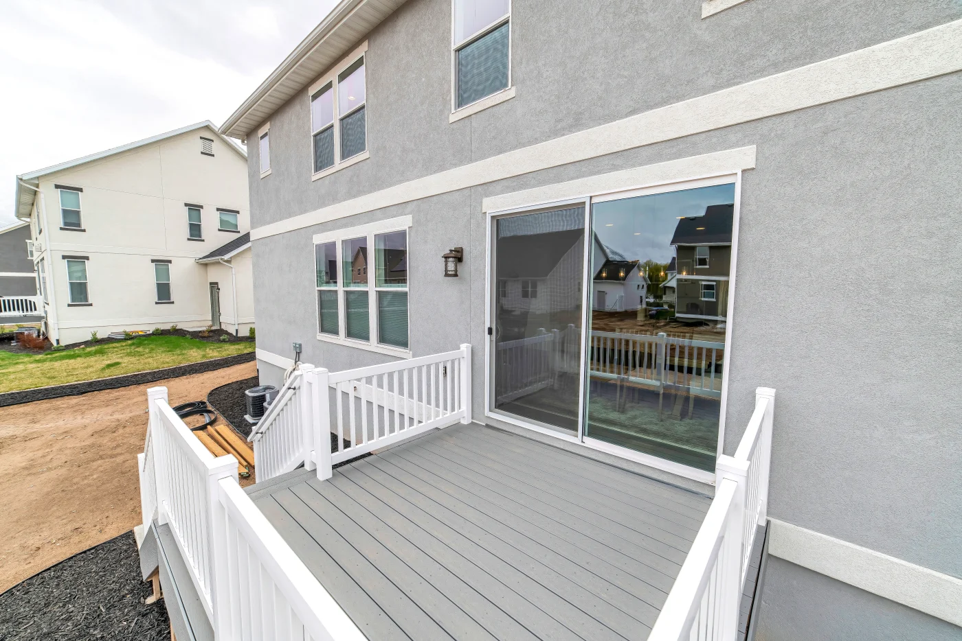 Sliding glass patio door on a pink house and patio