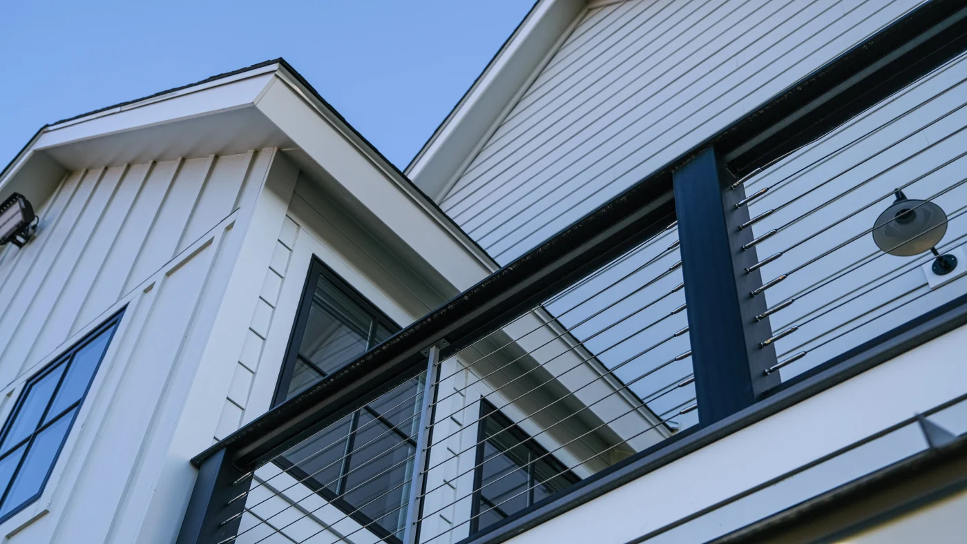 White siding on a two-story home in Evanston, IL, that was installed by Apex Exteriors
