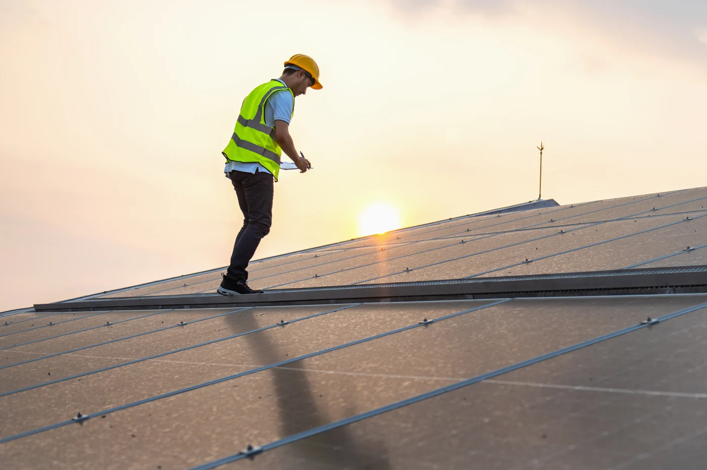 A professional roofer inspecting a large commercial roof