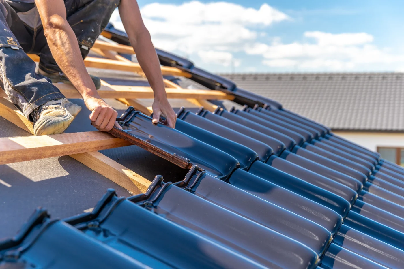 Close-up of a newly installed residential roof with dark, durable materials.